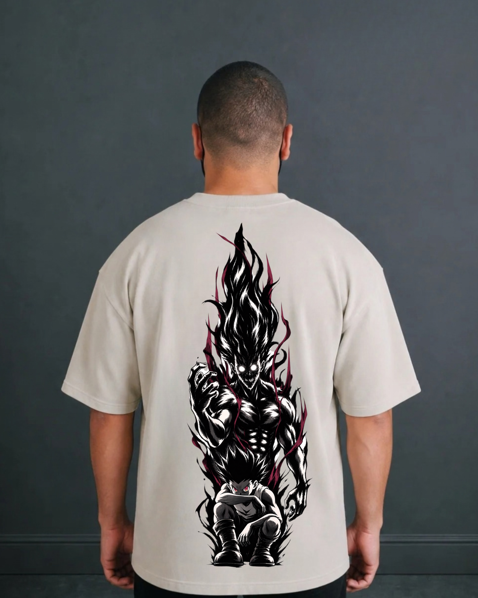 Back view of the ANIMURA Gon Rage Beige Oversized Anime T-Shirt showing Gon’s transformed silhouette in a crown of dark flame